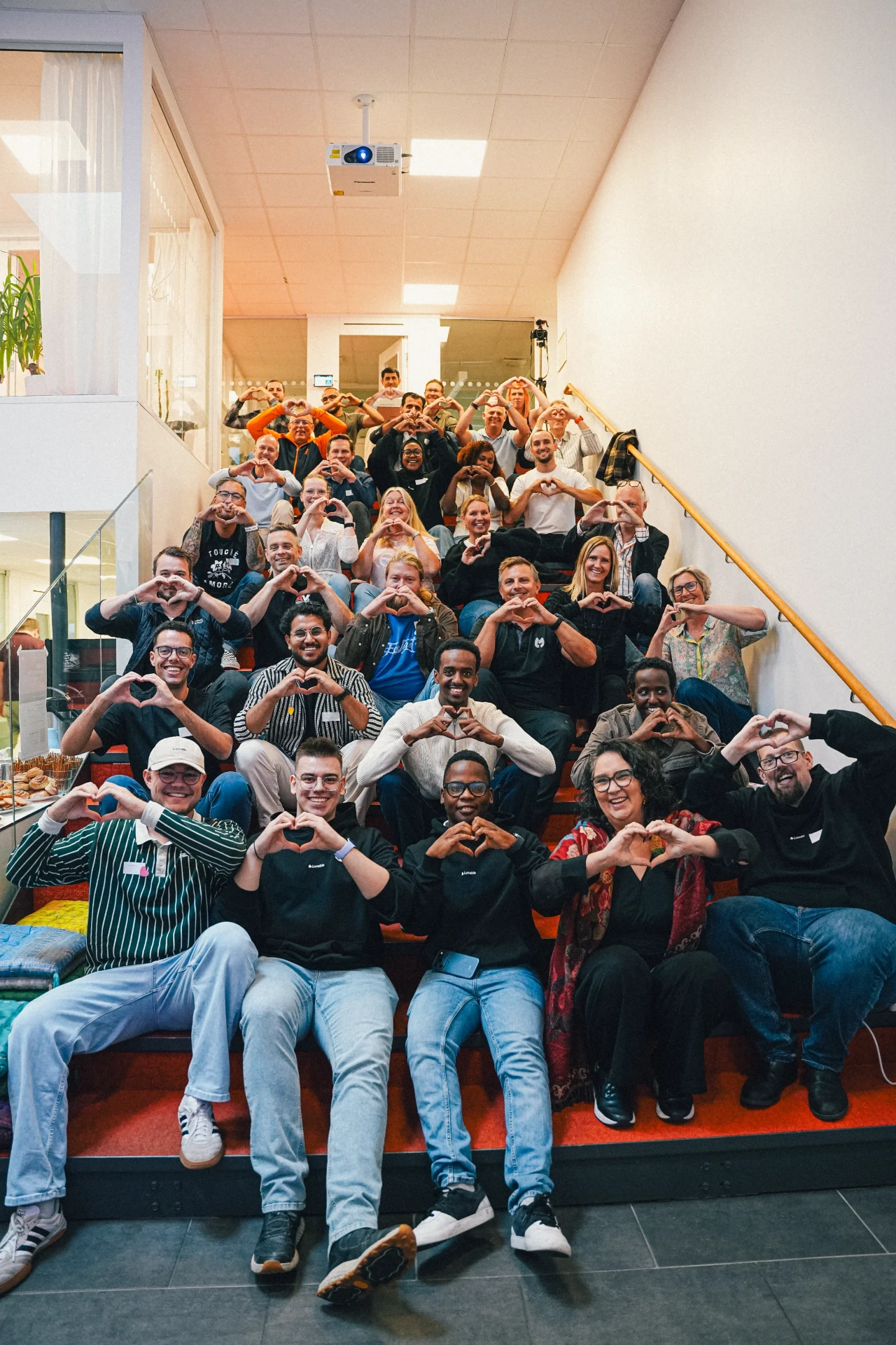 Lovable event group photo on the office stairs
